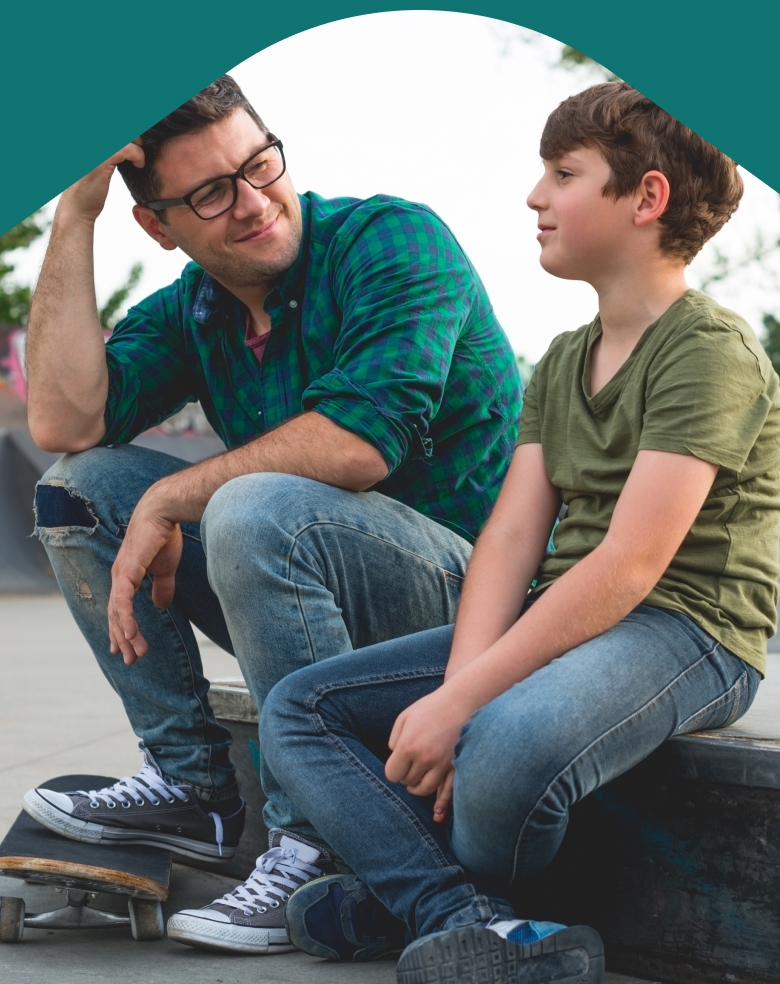 Photo: Father and child sitting in park