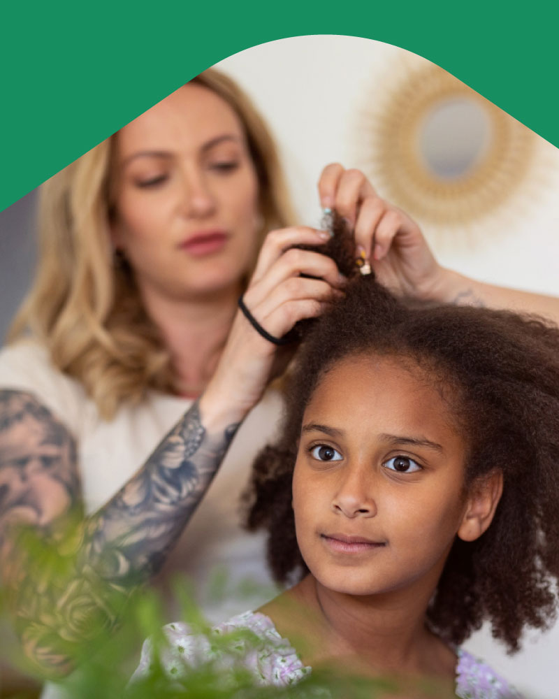 Photo: Mother doing daughter's hair
