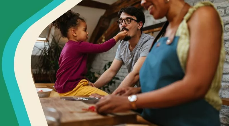 Photo: Parents cooking with child