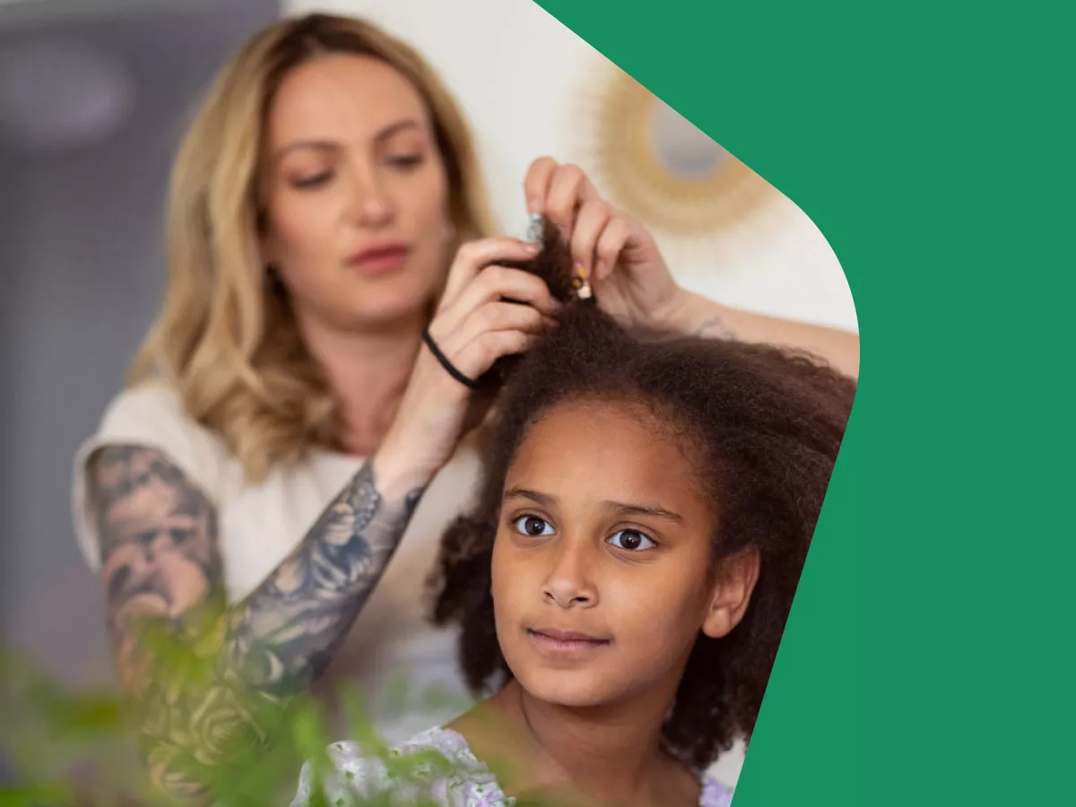 Photo: Mother doing daughter's hair